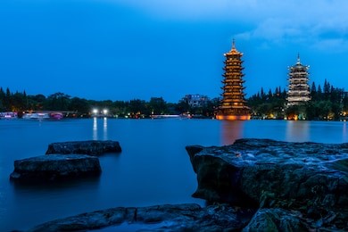 guilin, china two pagodas on lake during twilight