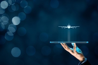 air ticket booking on digital tablet app or online travel insurance concepts. person with digital tablet and symbol of a plane.