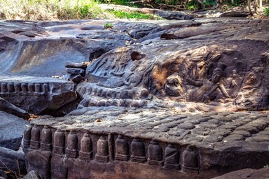 khmer riverbed carving at the river of a thousand lingas / sahasralingas (linga 1,000) of kbal spean. phnom kulen national park (phnom koulen, mountain of lychees), siem reap, cambodia.