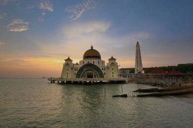 malacca straits mosque ( masjid selat melaka) with beautiful sunset background. it is a mosque located on the man-made malacca island near malacca town, malaysia                               