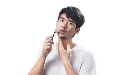 asian men mustache shaving, men's health face care.  young man hand touch chin and white t-shirt, isolated asian man portrait in white background with clipping path.