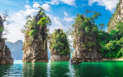 beautiful nature scenic landscape view rock mountain khao sok national park with boat for travelers, attractive famous popular place in thailand, destinations scenery asia, water travel adventure trip
