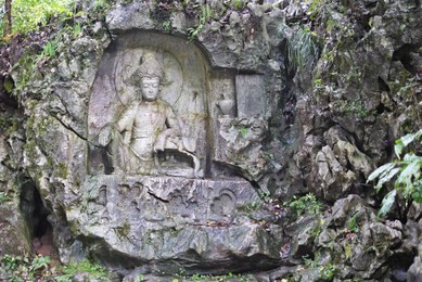 rock reliefs or rock carving at feilai feng or feilai grottoes in lingyin temple, hangzhou, zhejiang, china. the temple's name is translated as temple of the soul's retreat. 