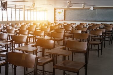 empty classroom with vintage tone wooden chairs. back to school concept.