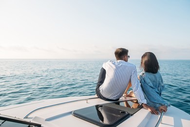 young clerk in casual office clothes made surprise for his girlfriend, he hired motorboat yacht which provides them with a peaceful atmosphere and privacy sailing in open sea, far from city noice