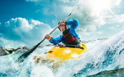 whitewater kayaking, extreme kayaking. a guy in a kayak sails on a mountain river