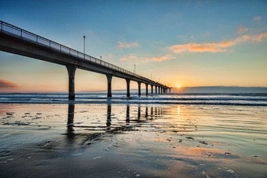 sunrise at new brighton pier, christchurch, new zealand.