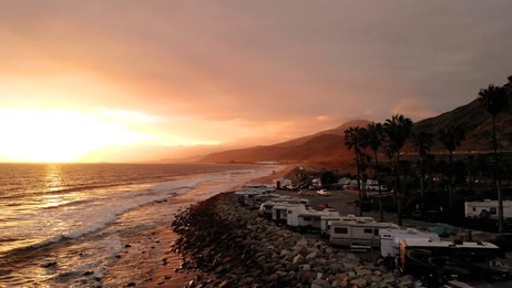 rv park (campground) at coast, california. ocean. california during sunset. aerial view, from above, drone flying over water.