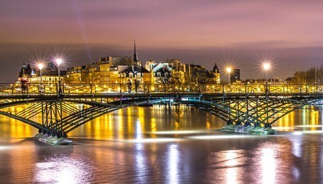 famous pont des arts in paris .seine river bridge at night. beautiful cityscape.