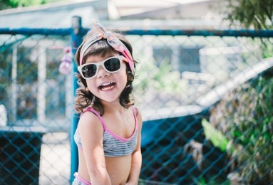 portrait of a little pretty asian girl wearing sunglasses 