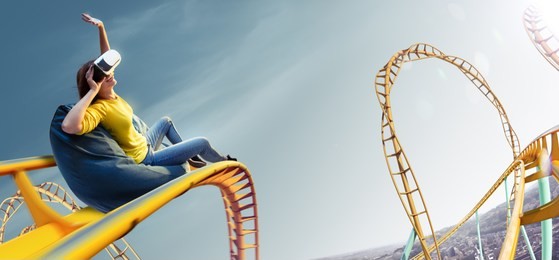 young woman used virtual reality helmet vr. she see roller-coaster park