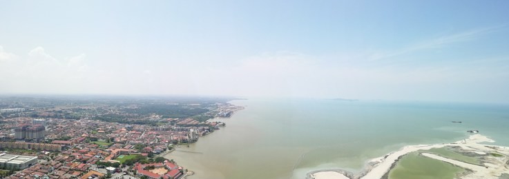 panorama view of malacca town and  strait of malacca sea from skydeck hattan hotel, malacca.