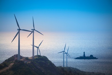 wind turbines generating electricity at the beach,green energy background