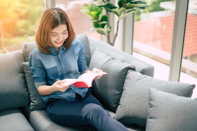 beautiful asian woman enjoy happiness hand reading book holiday weekend moment
