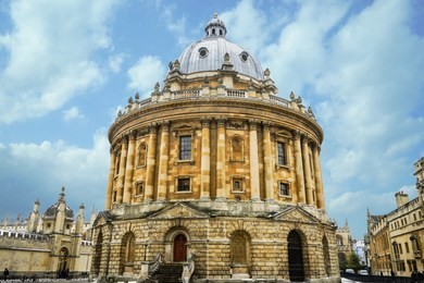 a library building in oxford universtiy called the radcliffe camera, bodleian library, oxford, england, united kingdom. on a beautiful blue sky day.