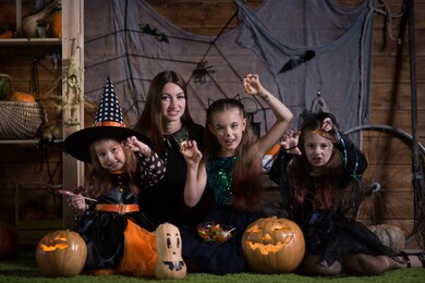 mom and children preparing for the holiday of halloween