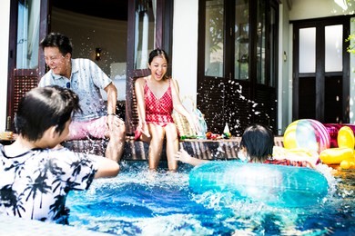 family playing in a pool