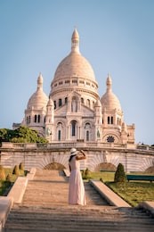 sacre coeur cathedral in montmartre, paris, france, young woman on the stairs of montmartre