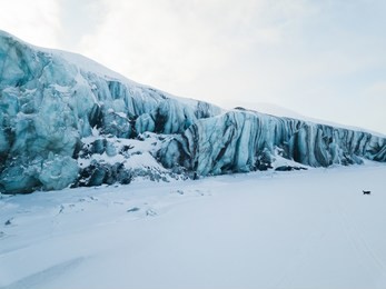 drone shots over the winter wonderland at the paula glacier on svalbard. stunning shades of blue.