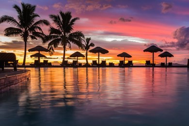 a beautiful sunset reflecting in the water in fiji