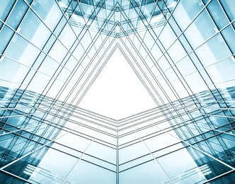 panoramic and perspective wide angle view to steel blue background of glass high rise building skyscrapers in modern futuristic downtown at night business concept of successful industrial architecture