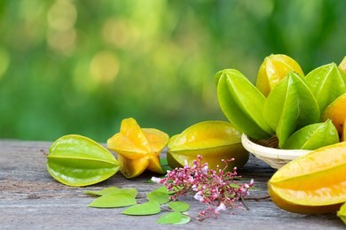 star apple fruit, organic fresh star fruit or carambola (averrhoa carambola) on wooden table concept for herbal plant