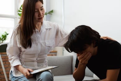 young asian man received a treatment from psychologist at clinic.