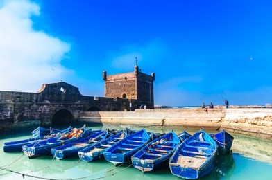 view on blue fisher rowing boats in the port of essaouira - morocco