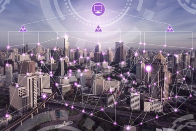 smart city wireless communication network with graphic showing concept of internet of things (iot) and information communication technology (ict) against modern city buildings in the background.