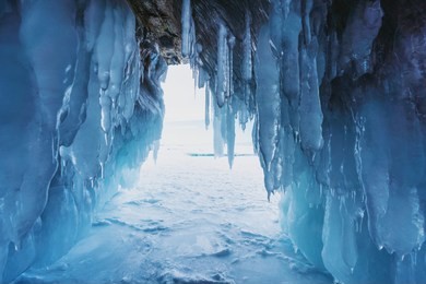 winter frozen ice cave at frozen lake baikal in siberia, russia