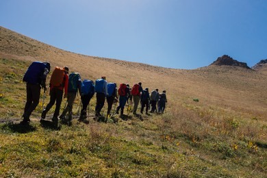 a group of climbers is going to the summit. teamwork and sports theme.