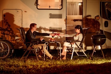 adult couple clinking glasses of wine. family vacation travel rv, holiday trip in motorhome, caravan car vacation.