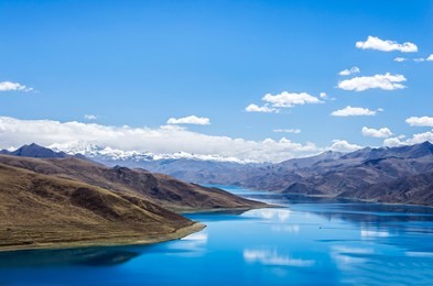 yamdrok lake"the fifth largest lake in the tibet,china.beautifual blue lake on highest land with mountains under blue sky and white clouds.landmark of tibet.