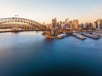 aerial view of sydney city skyline during sunrise.