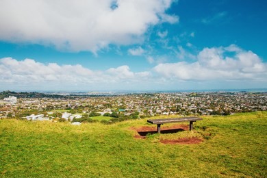 auckland view from mt eden with a person walking along the path towards the city, new zealand