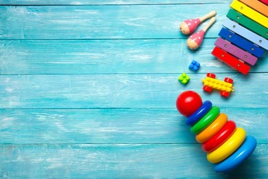 colorful kids toys frame on wooden background. top view. flat lay. copy space for text