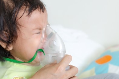 soft focus.asian children with nebulizer sickness respiratory syncytial virus.