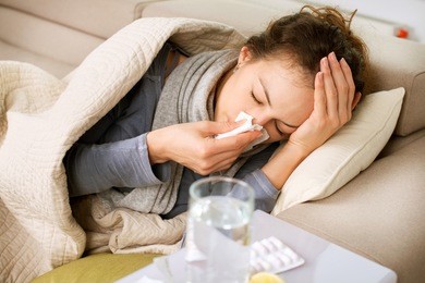 sick woman.flu.woman caught cold. sneezing into tissue. headache. virus .medicines