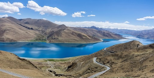 yamdrok lake"the fifth largest lake in the tibet,china.beautifual blue lake on highest land with mountains under blue sky and white clouds.landmark of tibet.