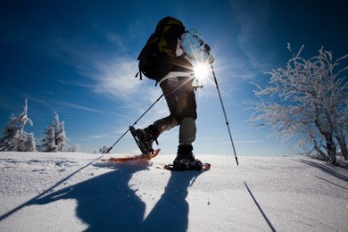 hiker in winter mountains snowshoeing