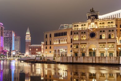 beautiful night view of amazing building in venetian style reflected in water in cotai of macau. wonderful cityscape. cotai is a new gambling and tourism area with casinos and shopping malls.
