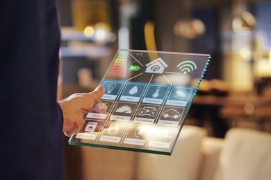 close-up of a glass tablet controls all the functions of the house such as wi-fi, heating, lighting, television through holography. concept of, home automation, automations, future, technology.