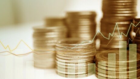 double exposure of city, graph and rows of coins for money, finance and business concept