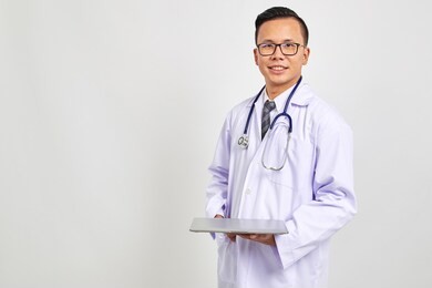 smiling asians doctor holding a digital tablet isolate on white background new medical concept