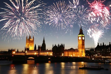 fireworks over palace of westminster seen from south bank