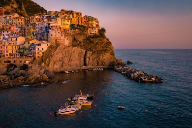 manarola village, cinque terre coast of italy. manarola a beautiful small town in the province of la spezia, liguria, north of italy and one of the five cinque terre travel attractions, sunset colors