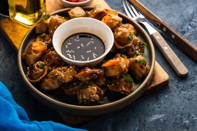 fried dumplings with soy sauce with pepper and green onions. asian cuisine.