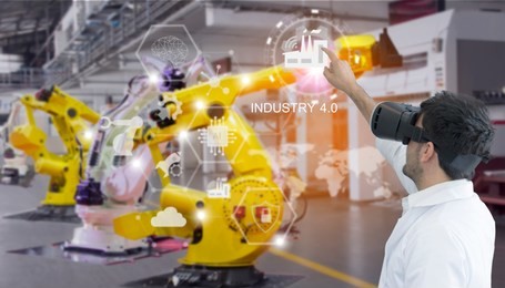 industry 4.0 robot concept .engineers are using virtual ar to maintain and check the work of human robot in the 4.0 smart factory.
