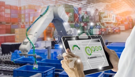 industry 4.0 robot concept .engineers use laptop computers for machine maintenance, automation tools, robot arm at the factory.