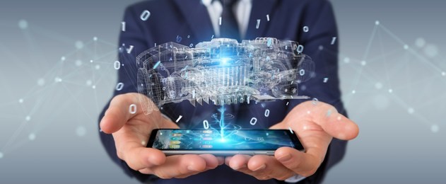 businessman using wireframe holographic 3d digital projection of an engine with mobile phone